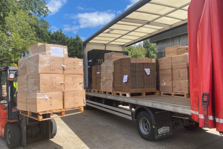 Loading a pallet of boxes onto one of our open side curtain lorries